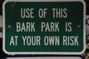 Sign saying "Use of this bark park is at your own risk"
