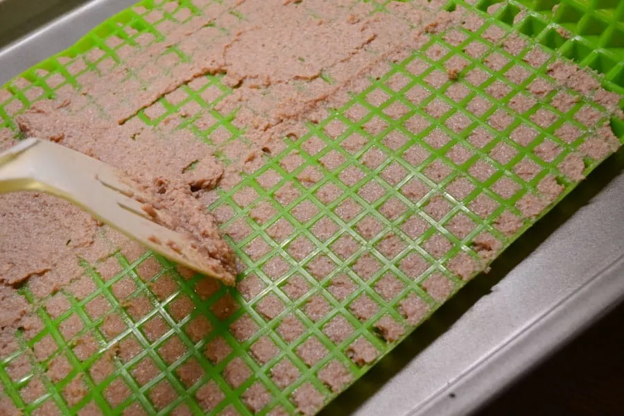 pyramid mat being used to add baby food mixture to create training treats for dogs
