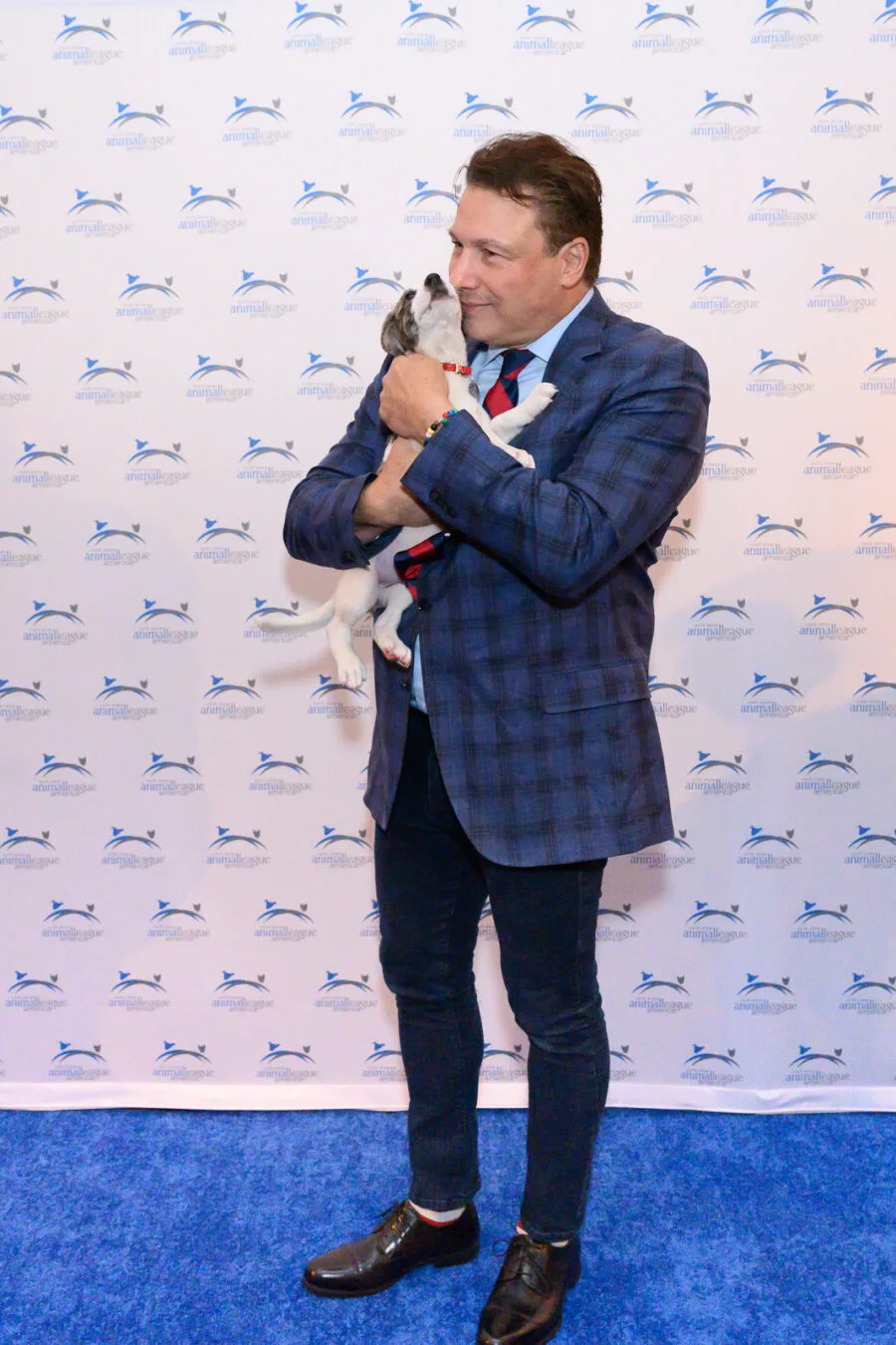 Chef/Best-Selling Author ROCCO DISPIRITO is greeted with puppy kisses at North Shore Animal League America’s CELEBRATION OF RESCUE. PHOTO CREDIT: AMY MAYES PHOTOGRAPHY