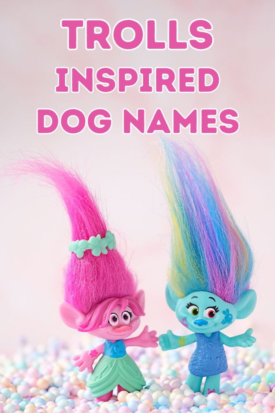 Cute friends trolls with colorful balls confetti on blurred pink background close-up.  Harper Pinsel and Queen Poppy - modern hasbro trolls.  Photo Shutterstock