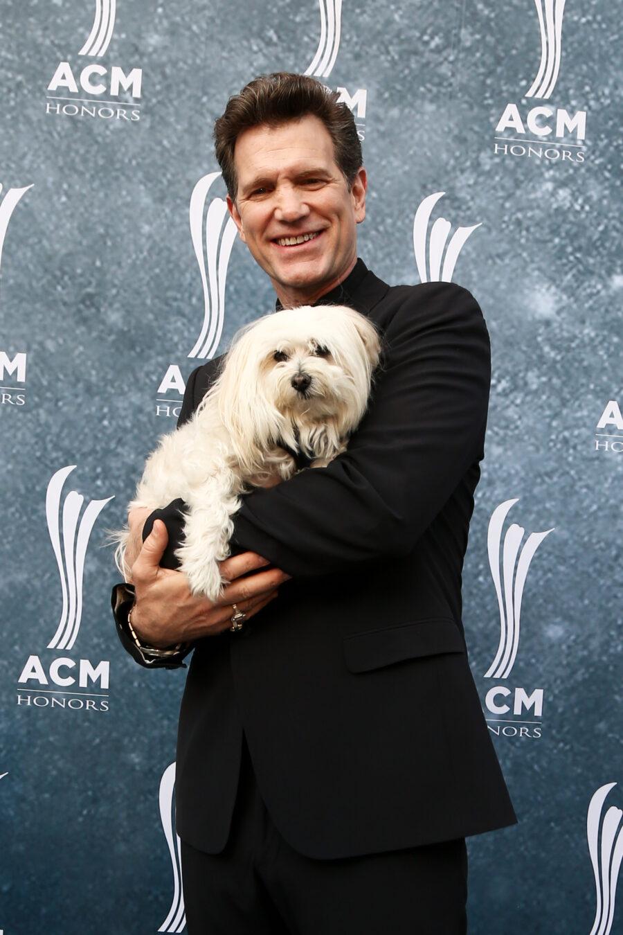 Chris Isaak and his dog, Rodney, attend the 9th Annual ACM Honors at the Ryman Auditorium on September 1, 2015 in Nashville, Tennessee. Shutterstock photo.